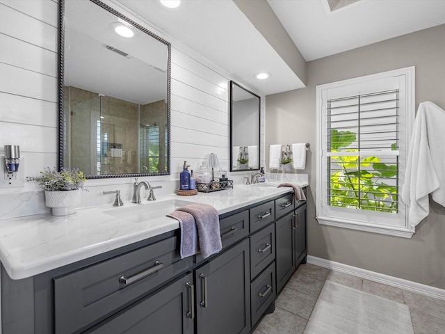 bathroom featuring tile patterned floors, a shower with shower door, and vanity