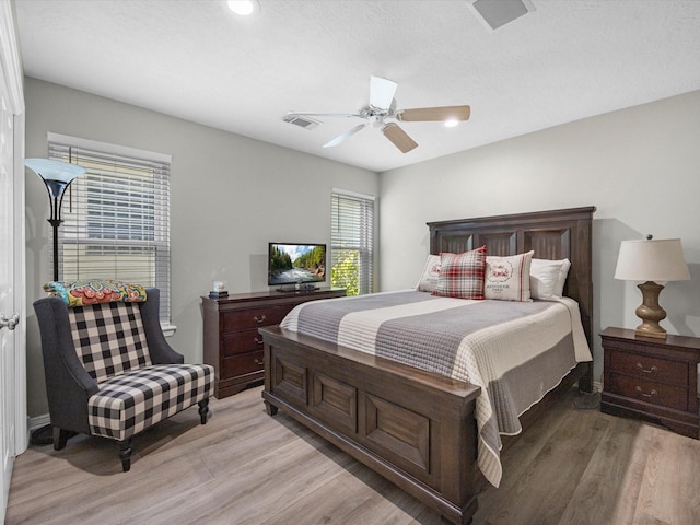 bedroom with ceiling fan and light hardwood / wood-style flooring