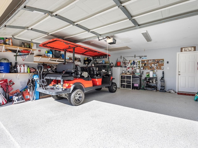 garage featuring a workshop area, white fridge, and a garage door opener