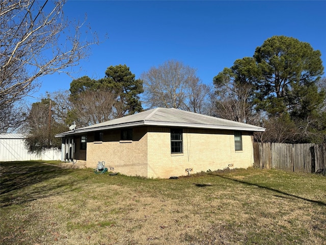 view of side of property with a lawn