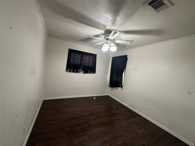 spare room with ceiling fan, dark wood-type flooring, and a textured ceiling