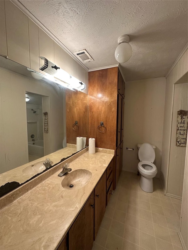 bathroom featuring toilet, a textured ceiling, ornamental molding, vanity, and wood walls