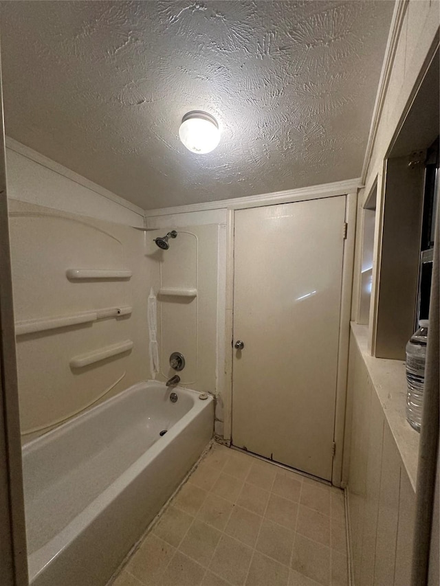 bathroom with a textured ceiling and shower / bathing tub combination