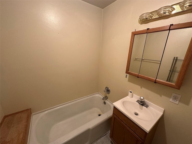 bathroom with a washtub, tile patterned floors, and vanity