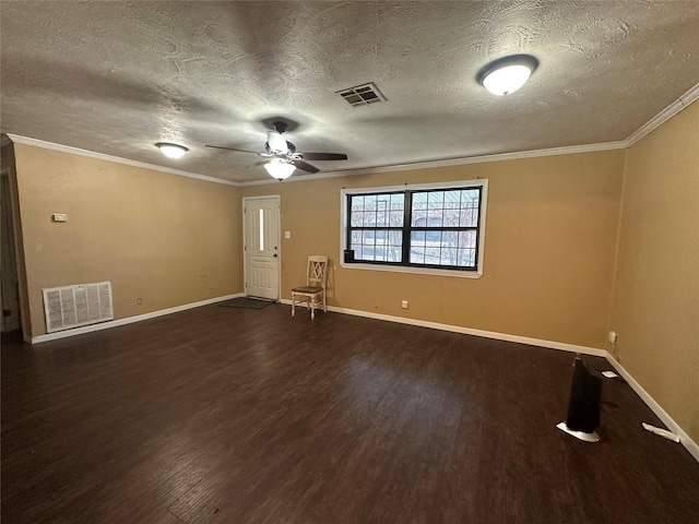 spare room with ornamental molding, ceiling fan, a textured ceiling, and dark hardwood / wood-style flooring