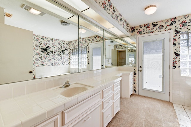 bathroom featuring tile patterned flooring and vanity