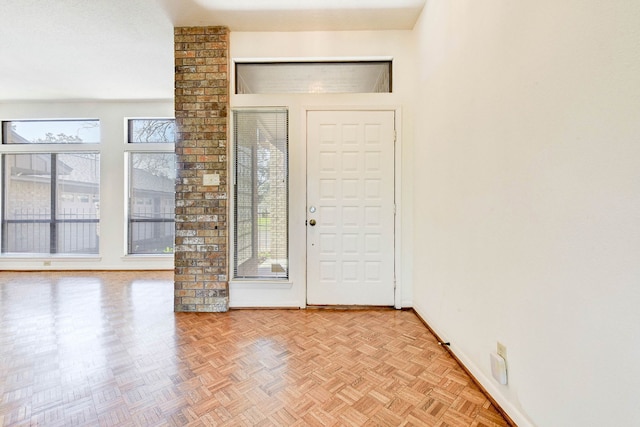 foyer featuring a healthy amount of sunlight and light parquet flooring