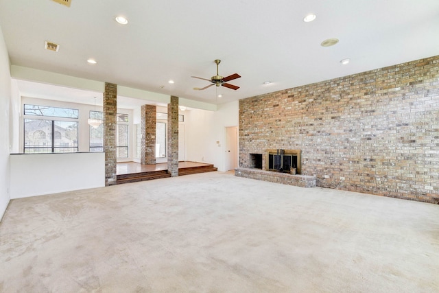 unfurnished living room featuring ceiling fan, carpet flooring, and a fireplace