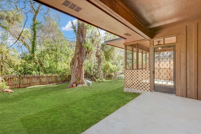 view of yard with a sunroom and a patio