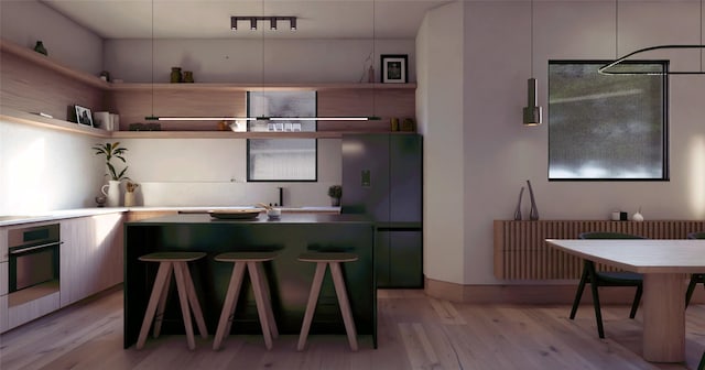 kitchen with track lighting, light hardwood / wood-style floors, and black appliances