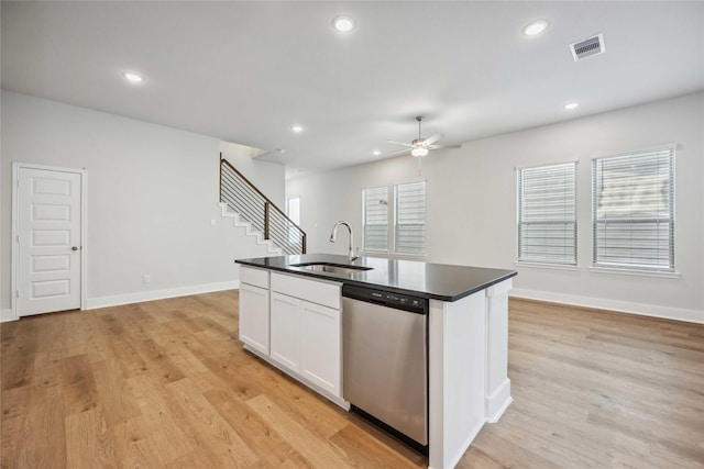 kitchen with light hardwood / wood-style floors, dishwasher, white cabinetry, sink, and an island with sink