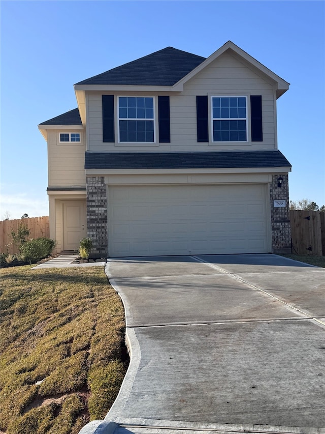 view of property with a garage and a front yard