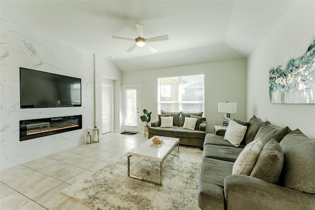 tiled living room with ceiling fan, a fireplace, and lofted ceiling