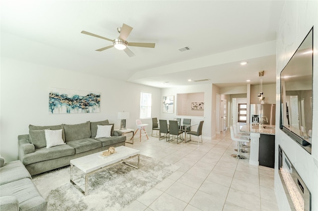 tiled living room with ceiling fan