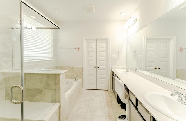 bathroom featuring vanity, tile patterned floors, and plus walk in shower