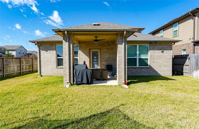 back of house featuring a patio area, a yard, and ceiling fan