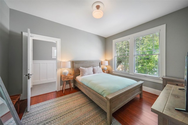 bedroom with dark hardwood / wood-style flooring