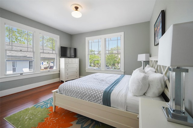 bedroom with dark wood-type flooring