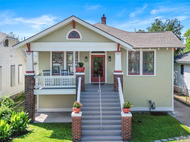 bungalow-style home featuring a garage and a porch