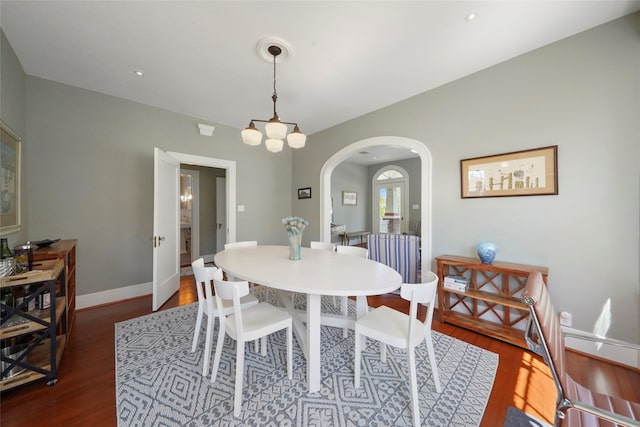 dining space with dark hardwood / wood-style flooring