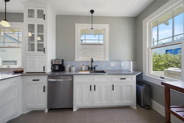 kitchen featuring pendant lighting, dishwasher, white cabinetry, decorative backsplash, and sink