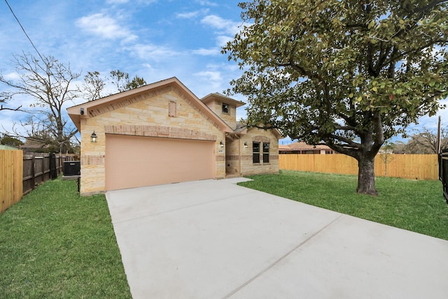 view of front facade with a garage, central AC, and a front yard