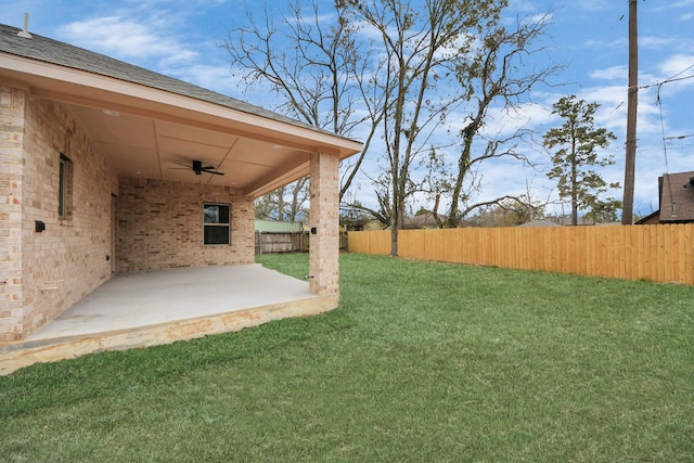 view of yard with a patio and ceiling fan