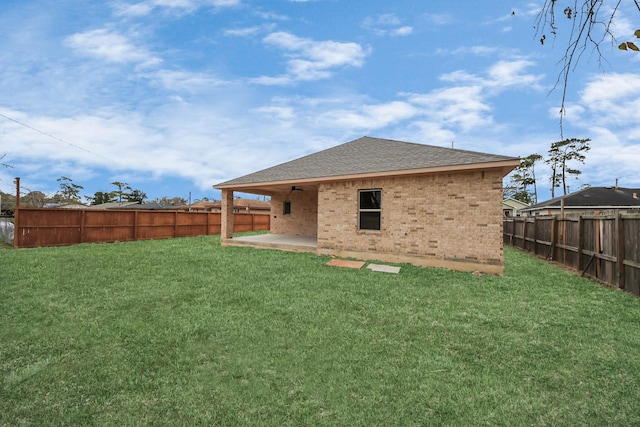 rear view of house with a patio and a yard