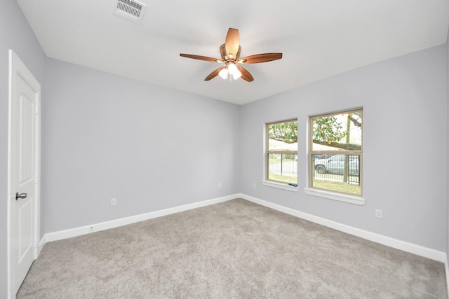 carpeted spare room featuring ceiling fan