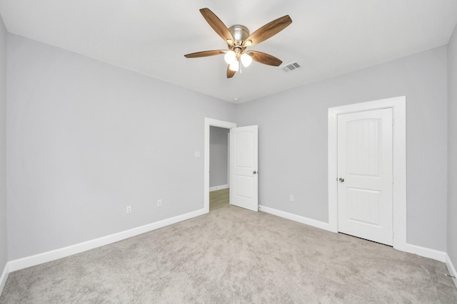 unfurnished bedroom with ceiling fan and light colored carpet