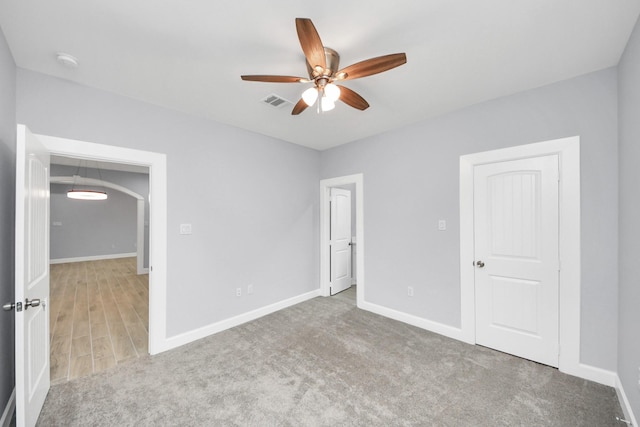 unfurnished bedroom featuring ceiling fan and carpet flooring