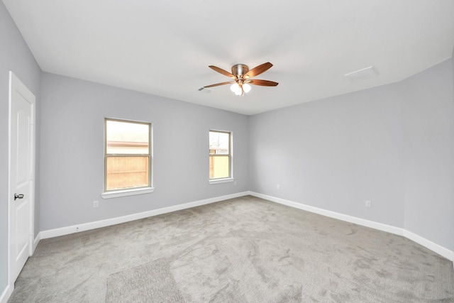 carpeted spare room with ceiling fan