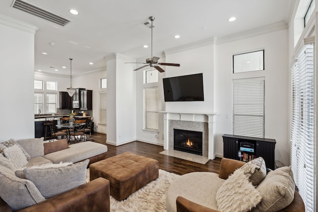 living room with ceiling fan, dark hardwood / wood-style flooring, and crown molding