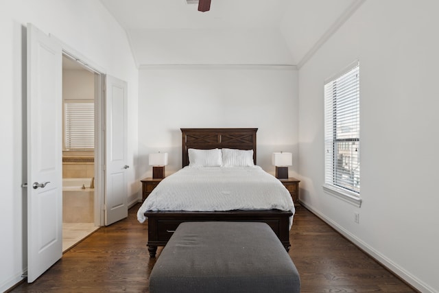 bedroom with ensuite bath, dark wood-type flooring, vaulted ceiling, and ceiling fan