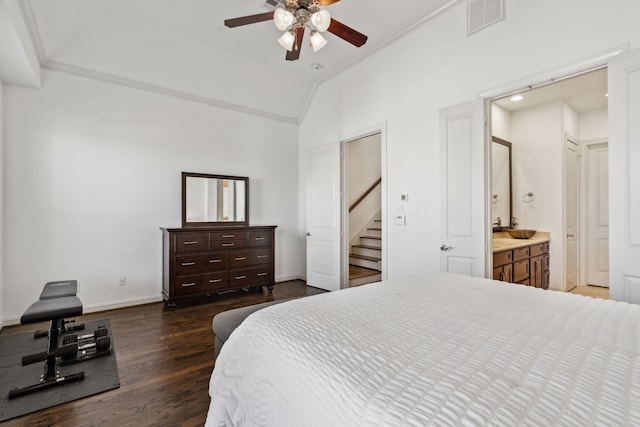 bedroom with ceiling fan, dark wood-type flooring, ensuite bath, ornamental molding, and lofted ceiling