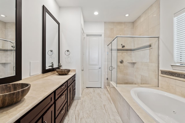 bathroom featuring independent shower and bath and vanity