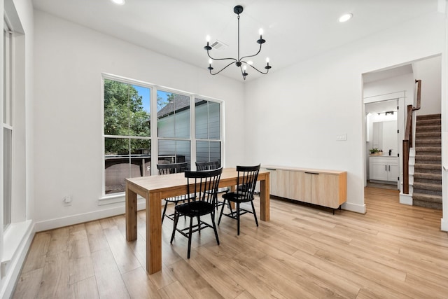 dining room featuring an inviting chandelier and light wood-type flooring