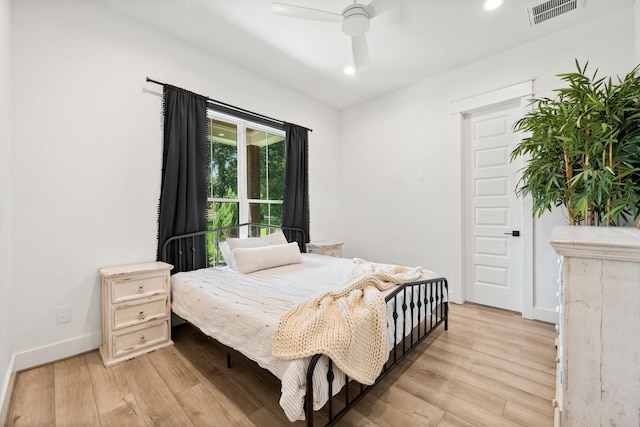 bedroom with light wood-type flooring and ceiling fan