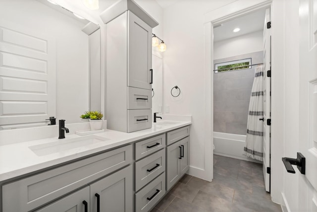 bathroom featuring shower / bath combo with shower curtain and vanity