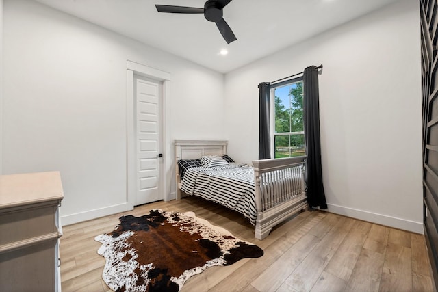 bedroom featuring light wood-type flooring and ceiling fan