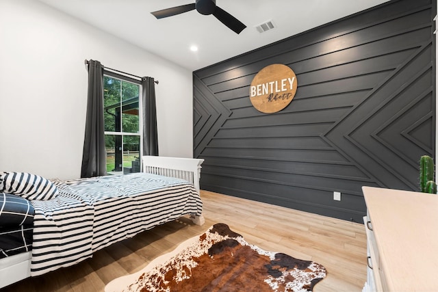 bedroom with hardwood / wood-style flooring and ceiling fan