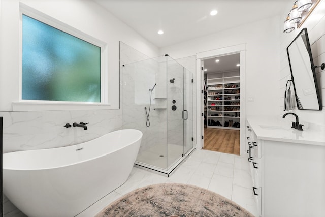 bathroom featuring vanity and shower with separate bathtub