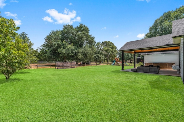 view of yard with an outdoor living space and a playground