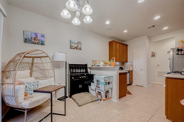 kitchen featuring kitchen peninsula, light tile patterned flooring, a notable chandelier, and stainless steel refrigerator