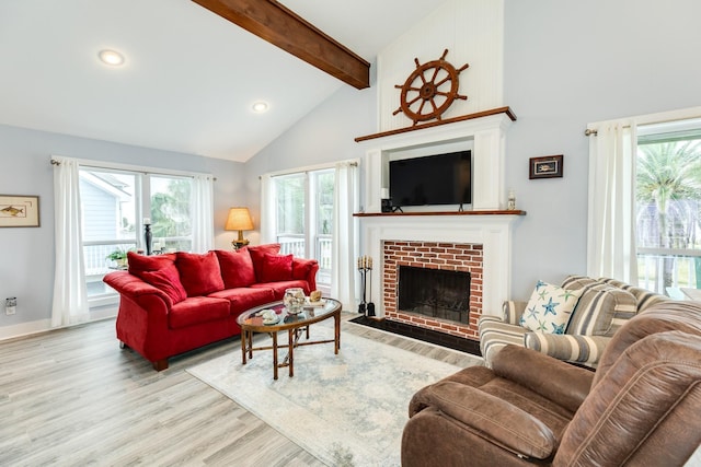 living room featuring beamed ceiling, a brick fireplace, high vaulted ceiling, and light hardwood / wood-style flooring