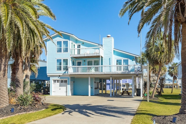 view of front facade with a garage, a carport, and a balcony