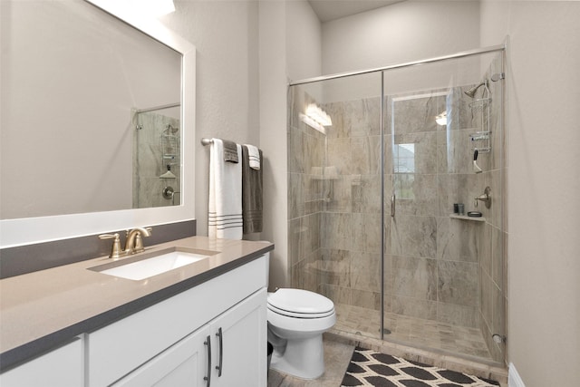 bathroom featuring vanity, toilet, walk in shower, and tile patterned flooring