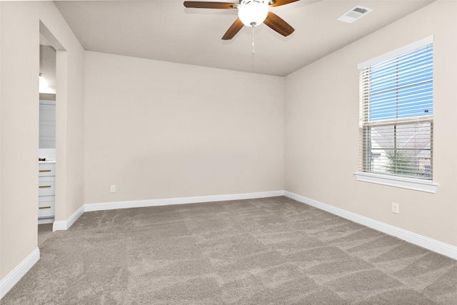 carpeted empty room featuring ceiling fan