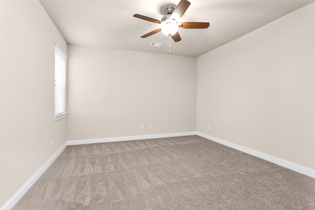 carpeted empty room featuring ceiling fan