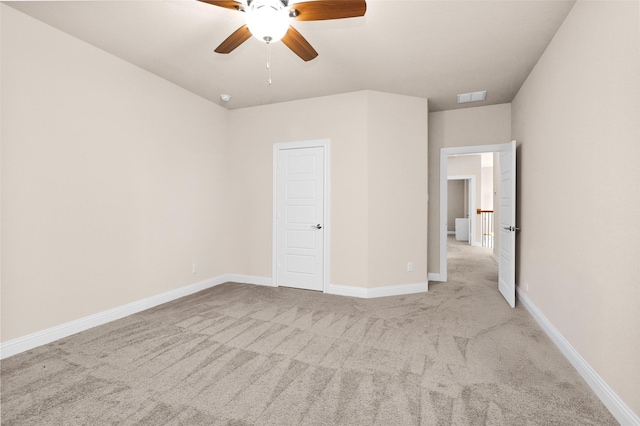 unfurnished bedroom featuring ceiling fan and light carpet